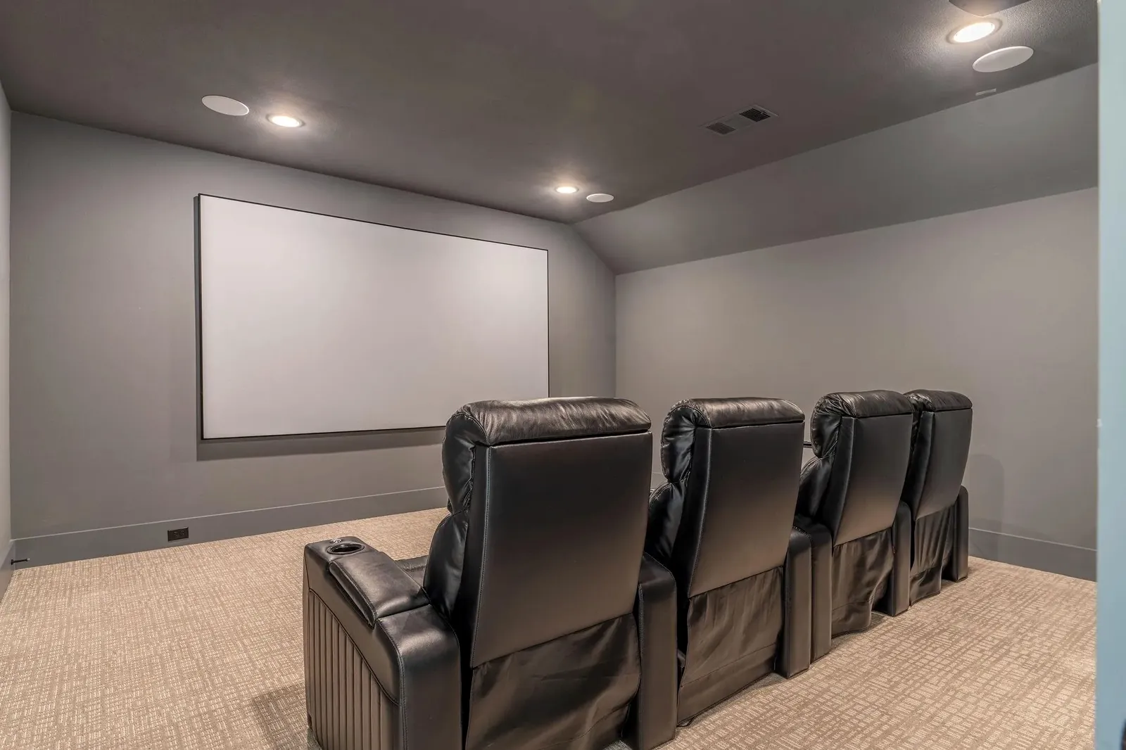 Dedicated home theater with a fixed screen and four seats